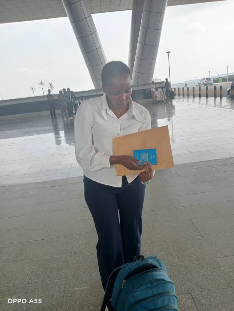 Traveler with a suitcase and documents outside the terminal