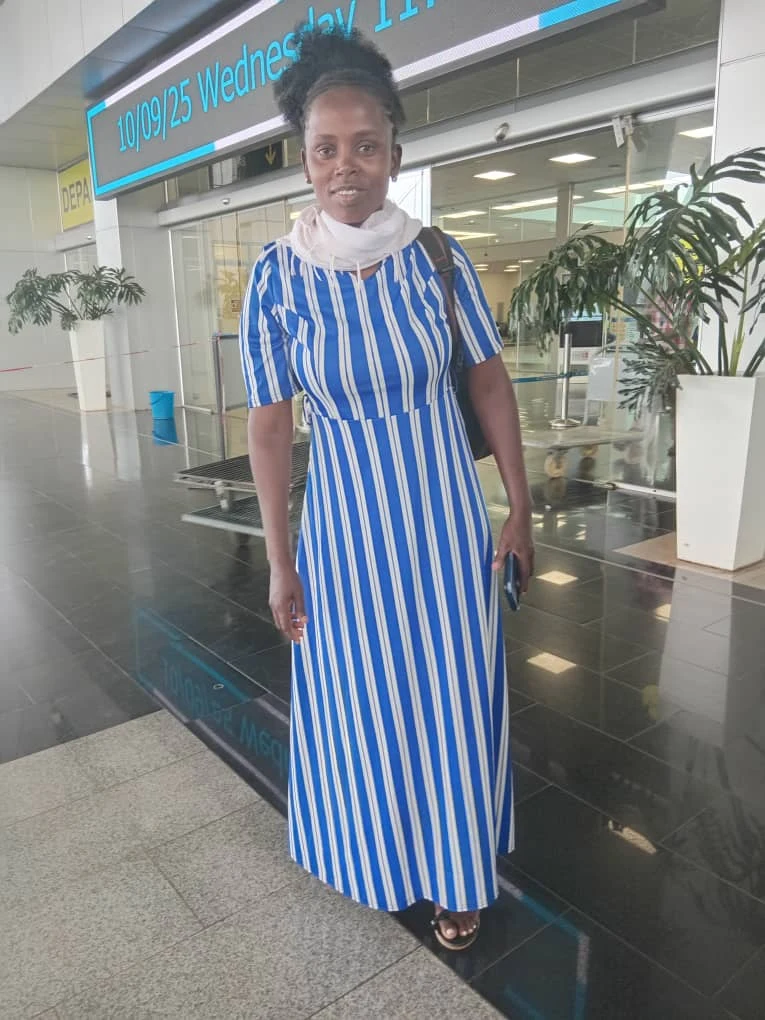 Traveler in a blue striped dress at the airport